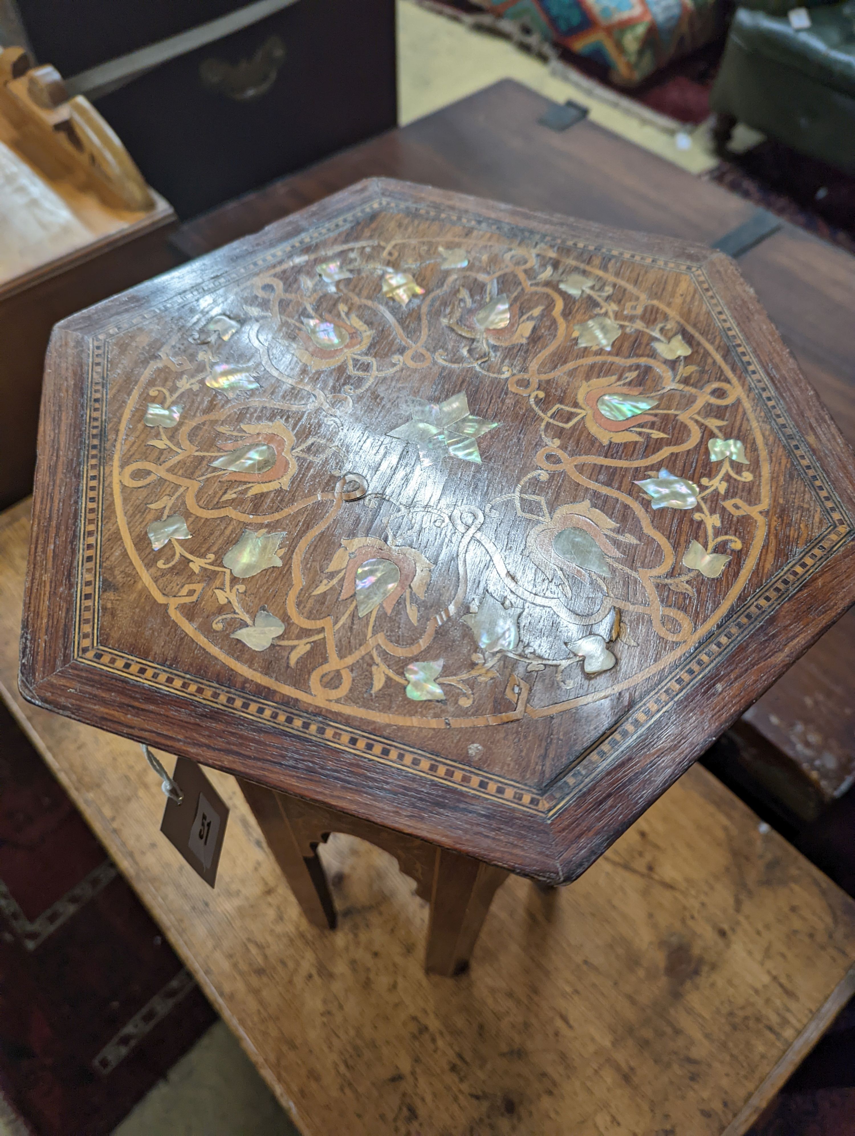 A Moorish mother of pearl and marquetry inlaid hexagonal occasional table, width 29cm, height 50cm